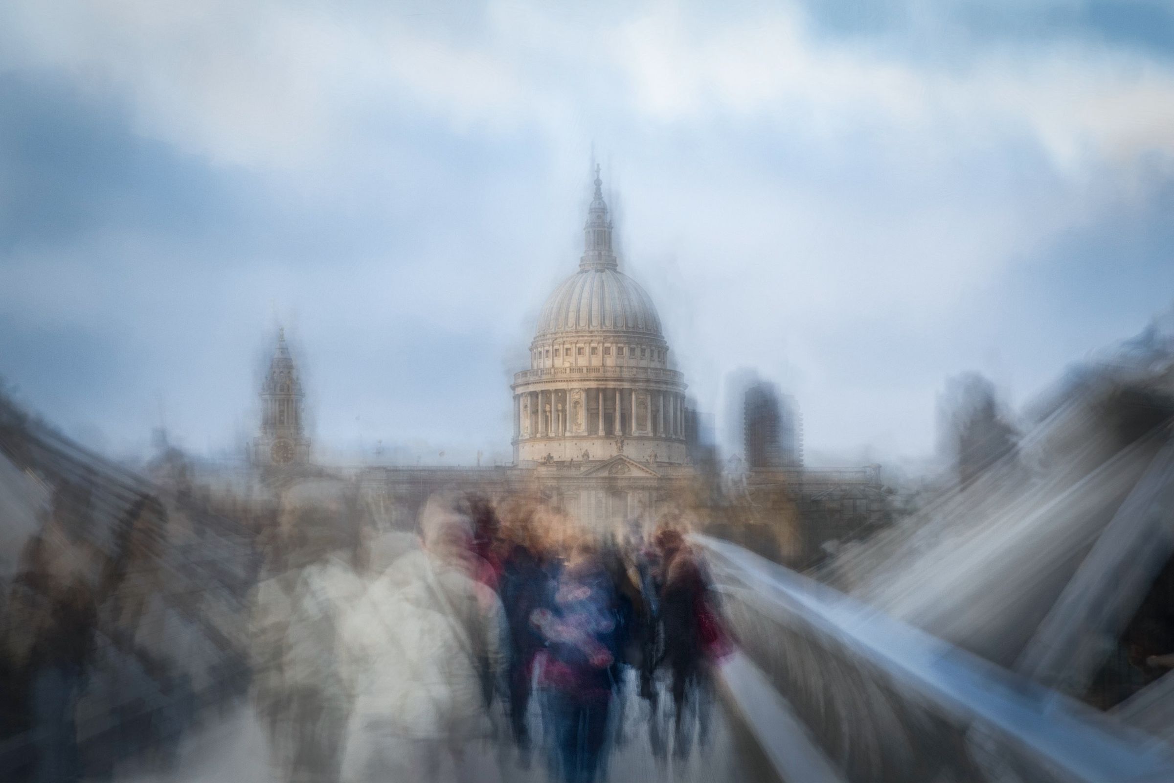 St Paul's Cathedral seen from the Millennium Bridge, the crowd in motion around it